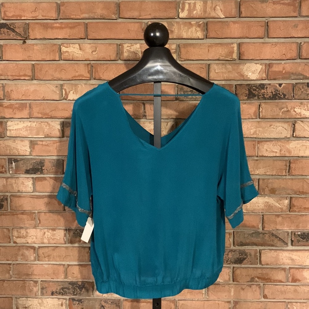 100% Silk Blouse in a soft teal color with beaded trim on sleeves. Size Large